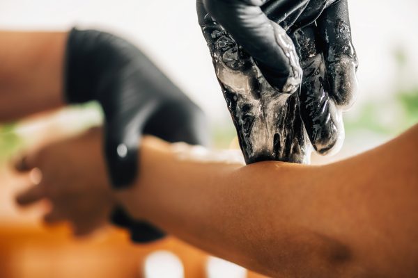 Sugar Paste Hand Depilation, Sugaring Hands Sugar paste hand depilation or sugaring hands. Beautician removing unwanted hair from female hand with sugar paste